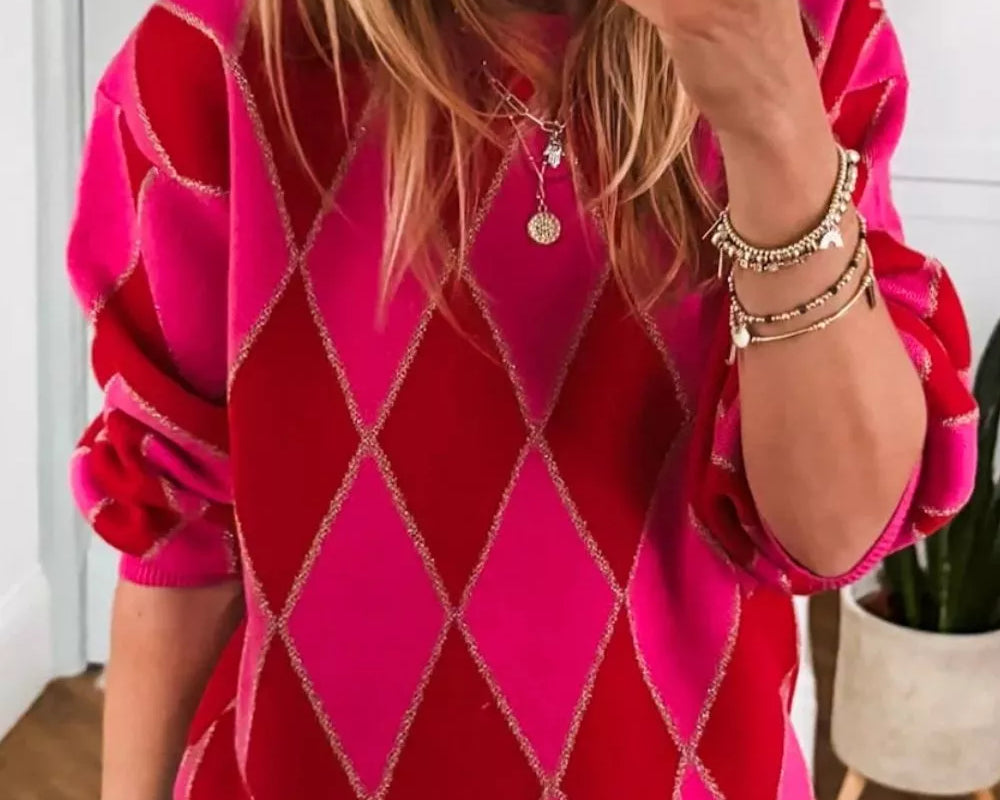 NEWYORKLISTED STYLE COLLECTION: Person wearing a pink and red argyle sweater taking a mirror selfie.