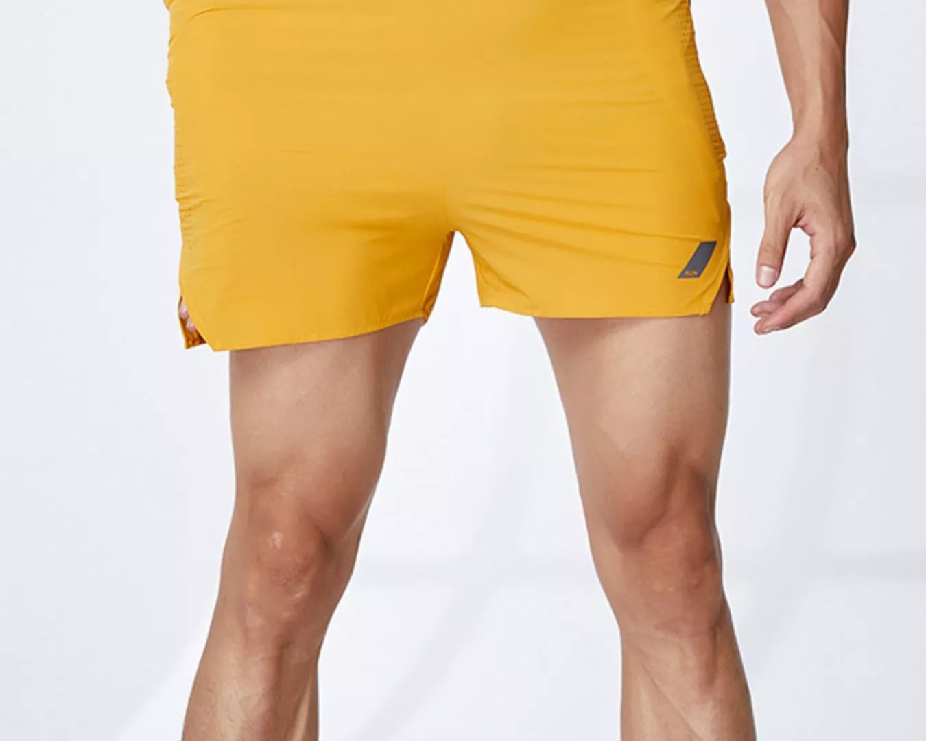 NEWYORKLISTED ATLAS MEN's COLLECTION: Yellow swim shorts with black waistband on a white background