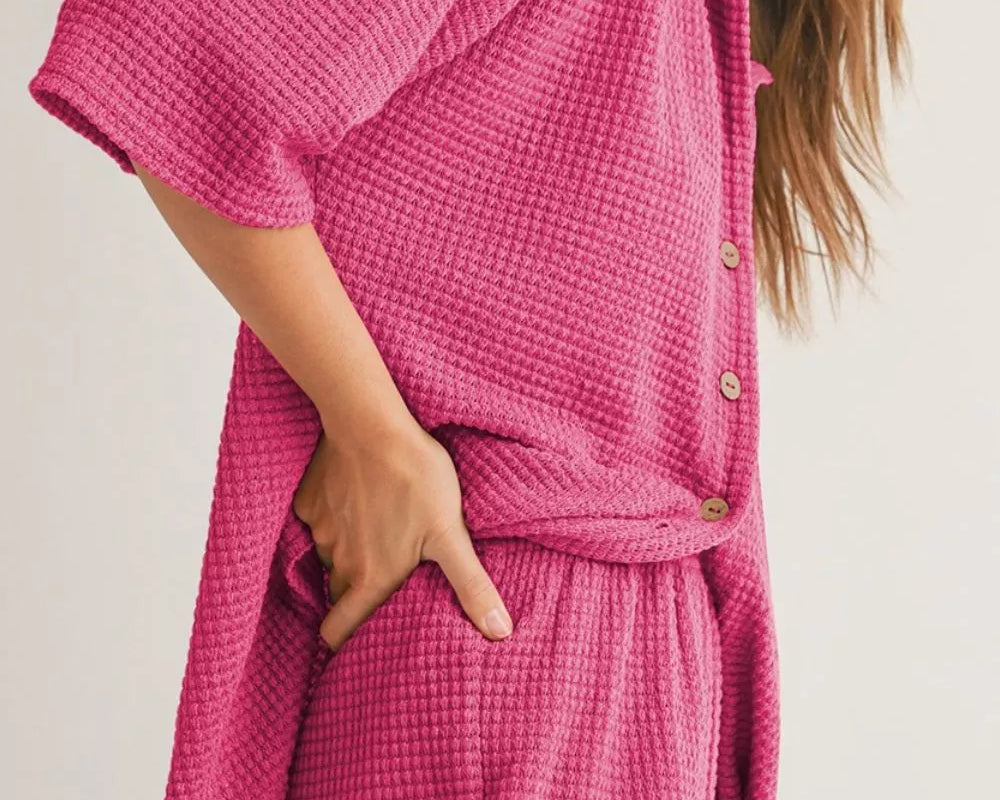 NEWYORKLISTED Comfort Collection: Woman wearing a pink textured outfit with a plain background