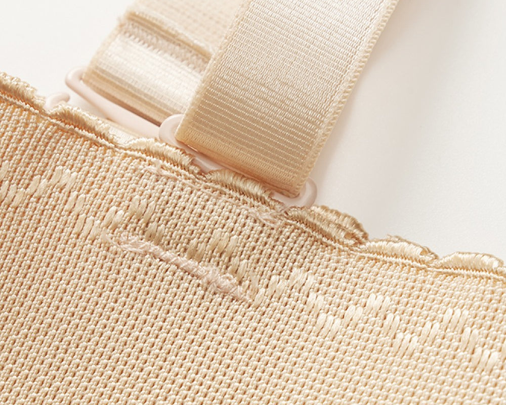 NEWYORKLISTED Intimate Apparel: Close-up of beige fabric with a strap on a white background