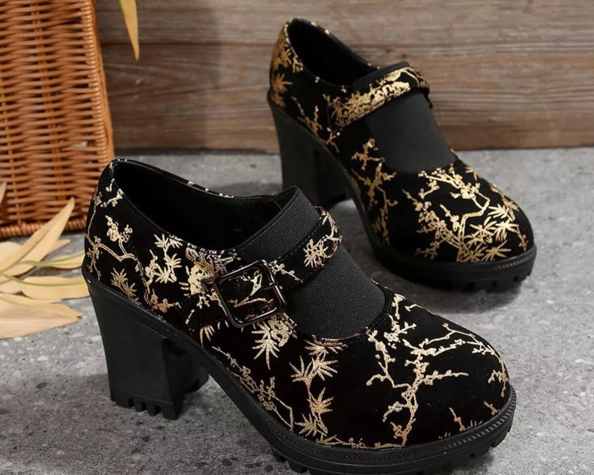 NEWYORKLISTED STYLE COLLECTION: Black shoes with gold floral patterns on a textured surface