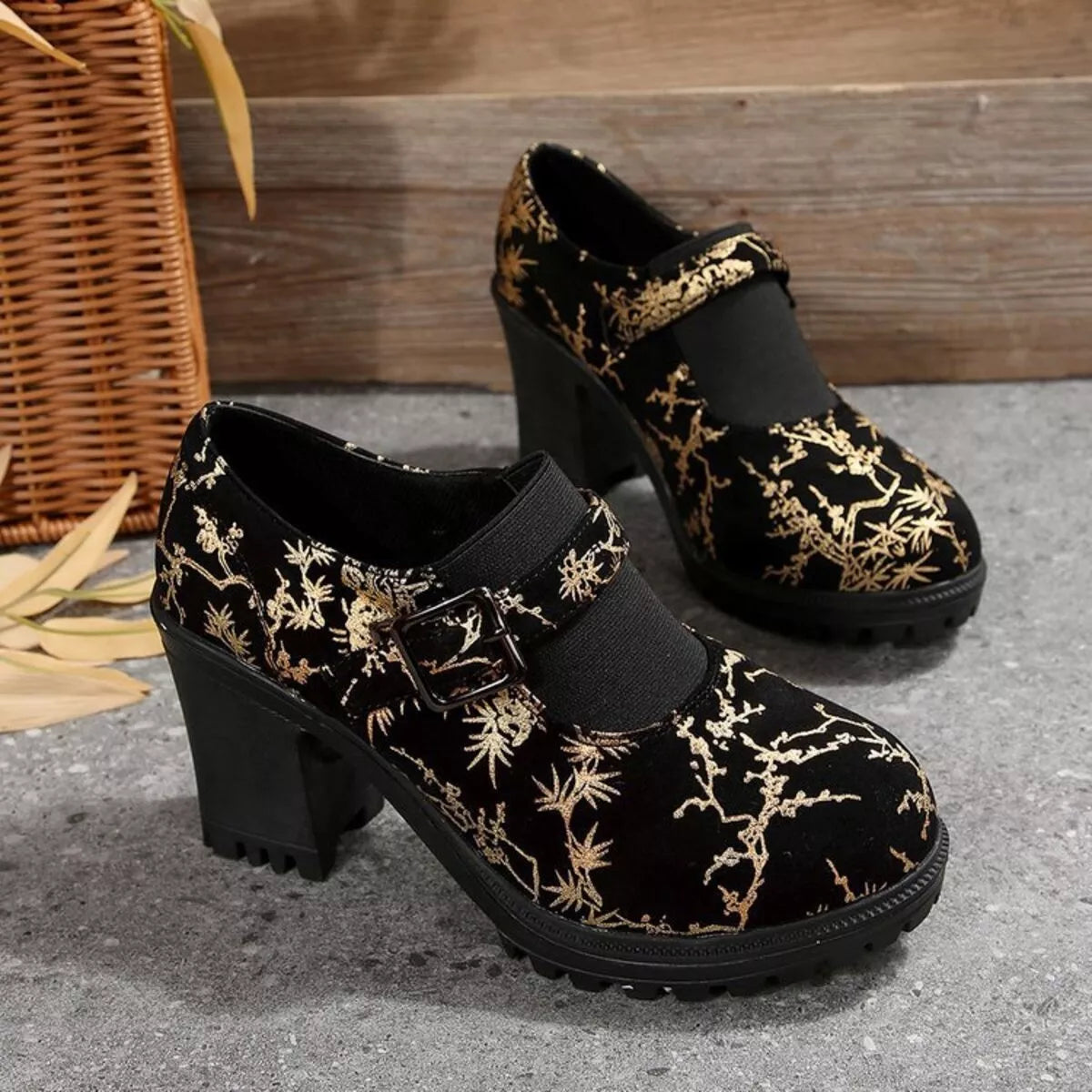 NEWYORKLISTED STYLE COLLECTION: Black shoes with gold floral patterns on a textured surface