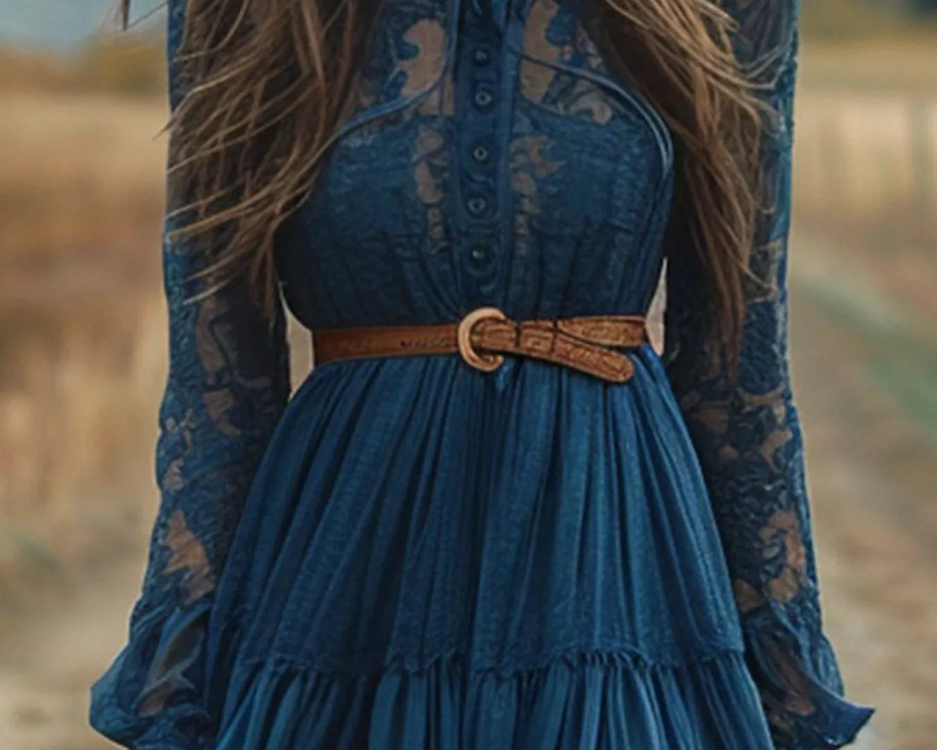 NEWYORKLISTED STYLE COLLECTION: Woman wearing a blue lace dress with a brown belt in a natural setting