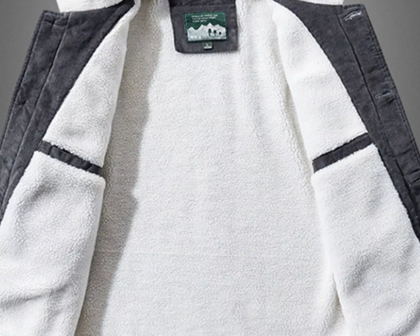 NEWYORKLISTED ATLAS MEN'S COLLECTION: White fleece jacket with gray accents on a gray background