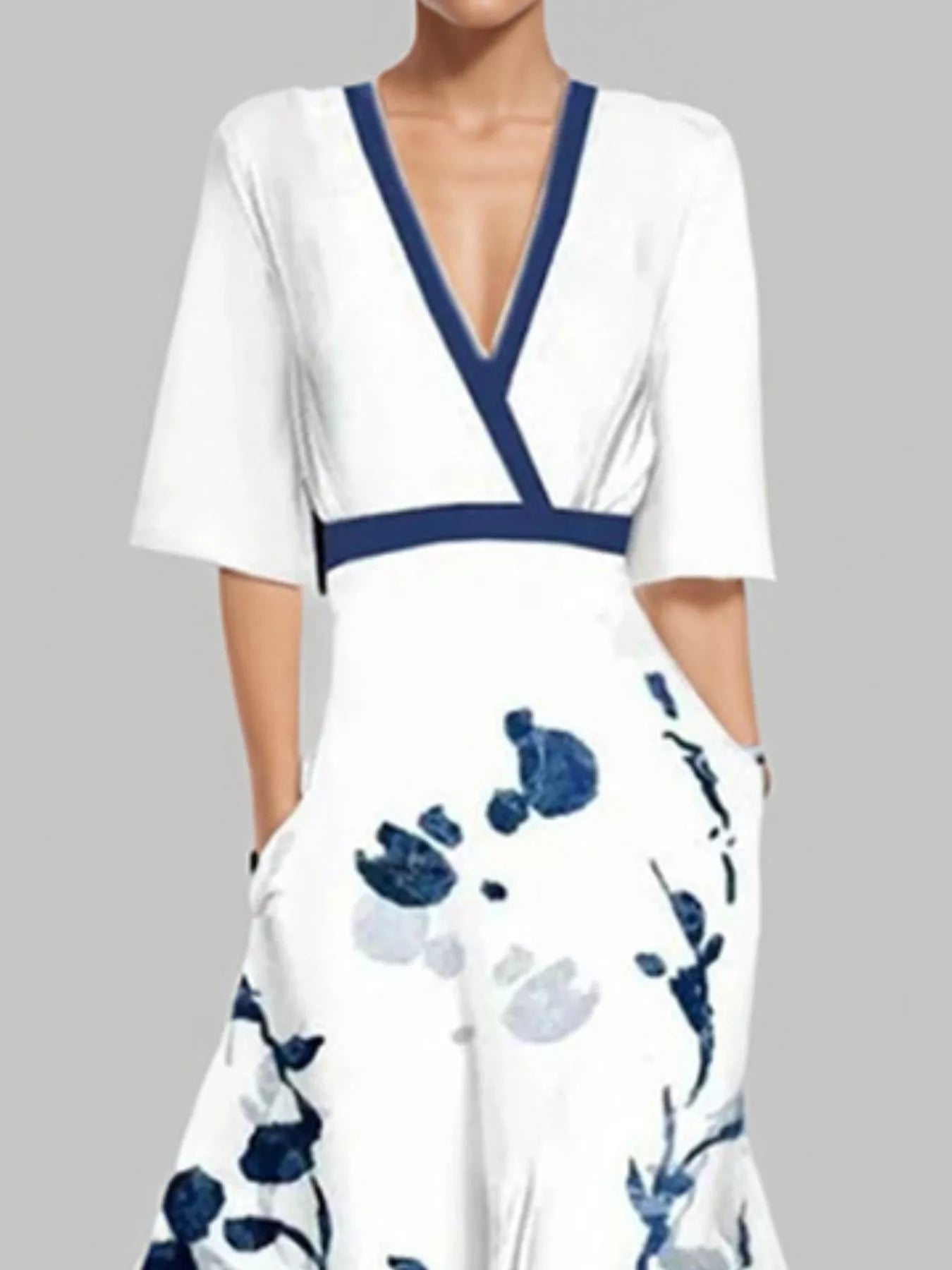 NEWYORKLISTED STYLE COLLECTION: White dress with blue floral pattern and neckline on a gray background