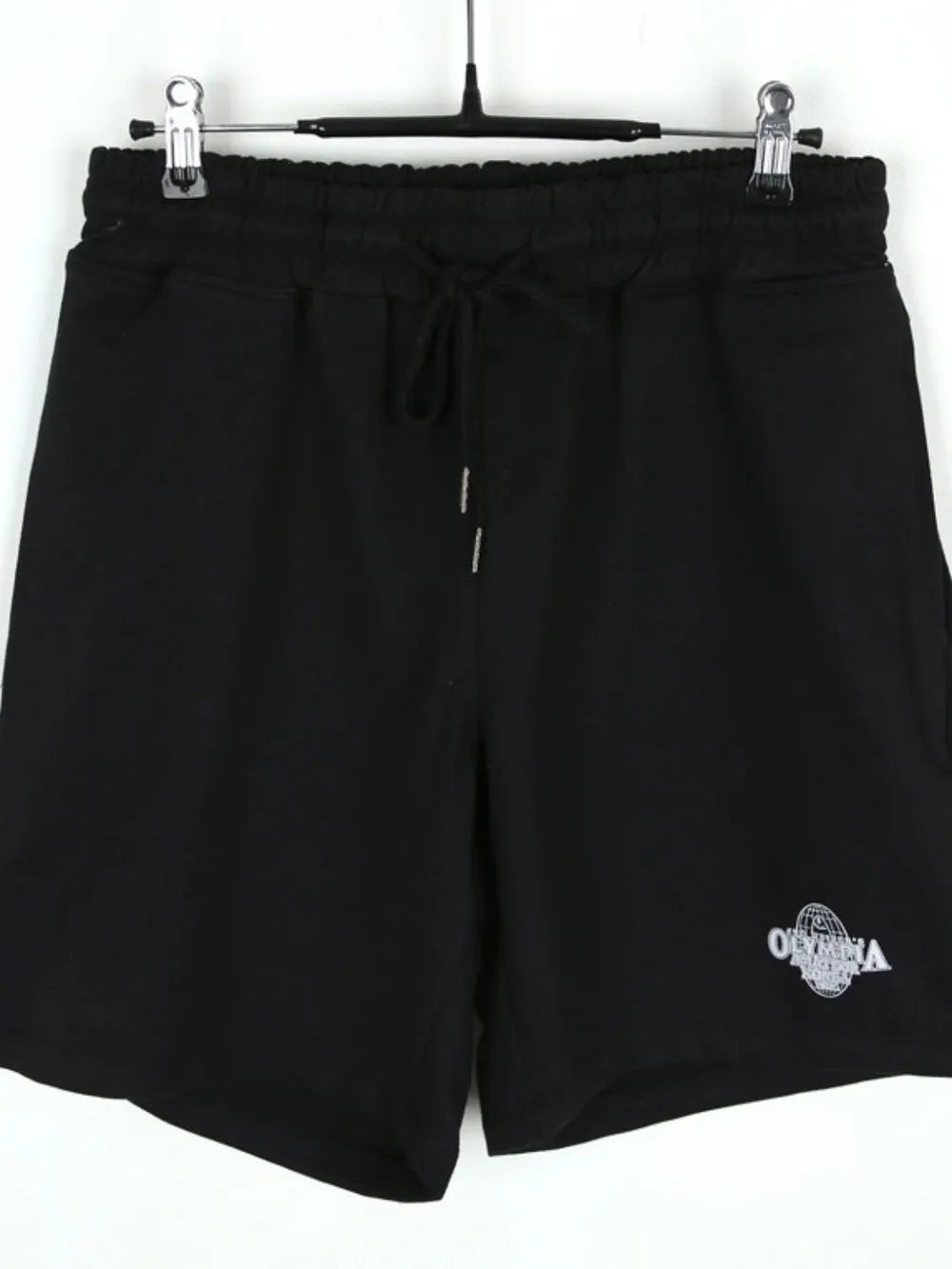 NEWYORKLISTED ATLAS MEN's COLLECTION: Black shorts with a logo on a hanger against a white background
