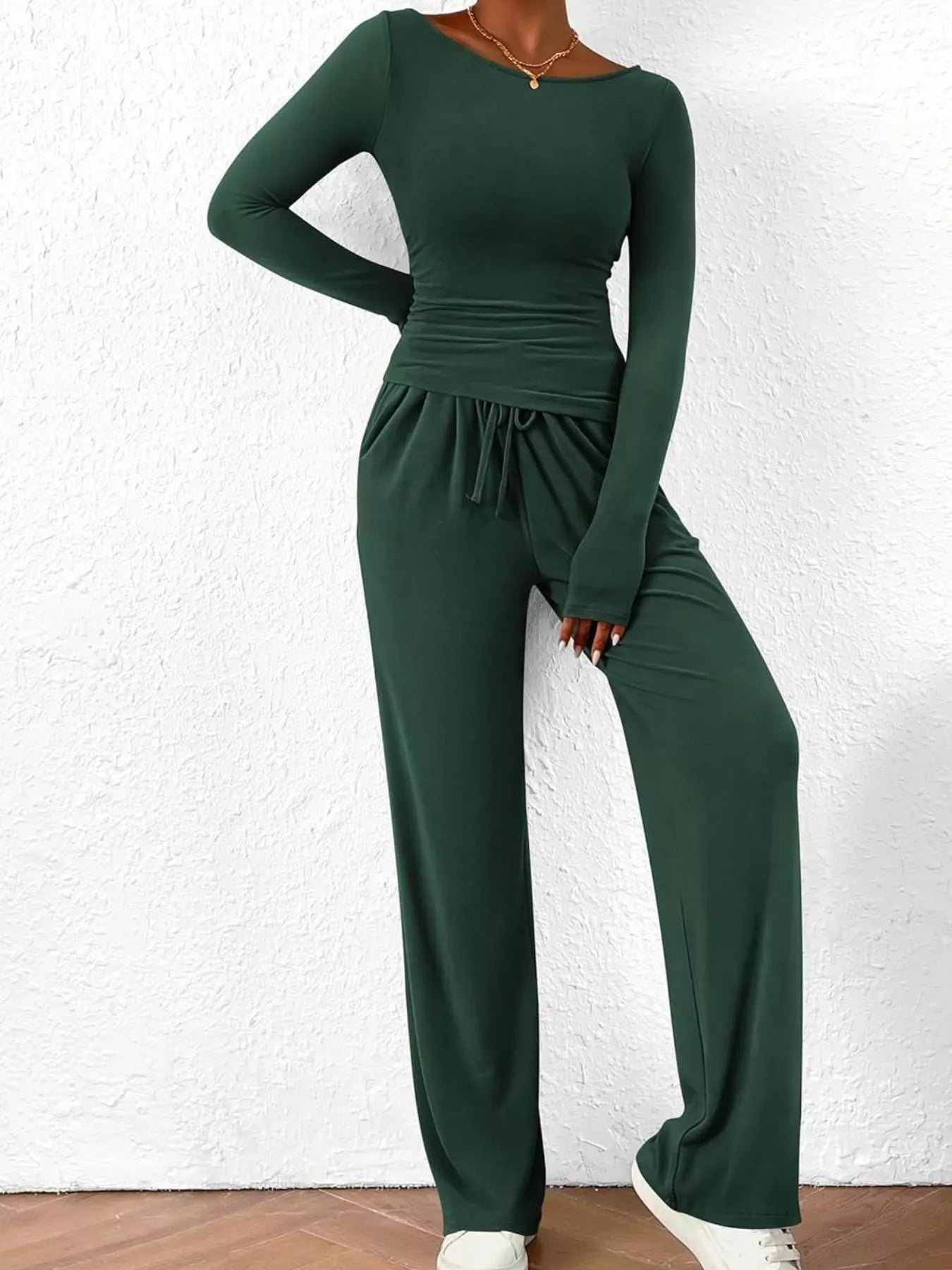 NEWYORKLISTED COMFORT COLLECTION: Long Sleeve Top and Wide Leg Pants Set: Green jumpsuit worn by a person against a white wall.