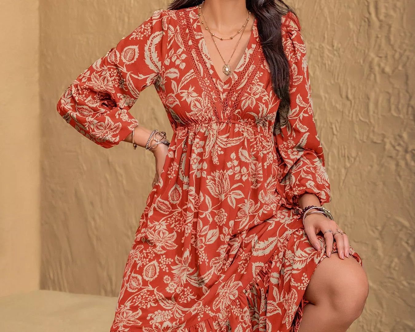 NEWYORKLISTED STYLE COLLECTION: Woman wearing a red floral dress against a beige background