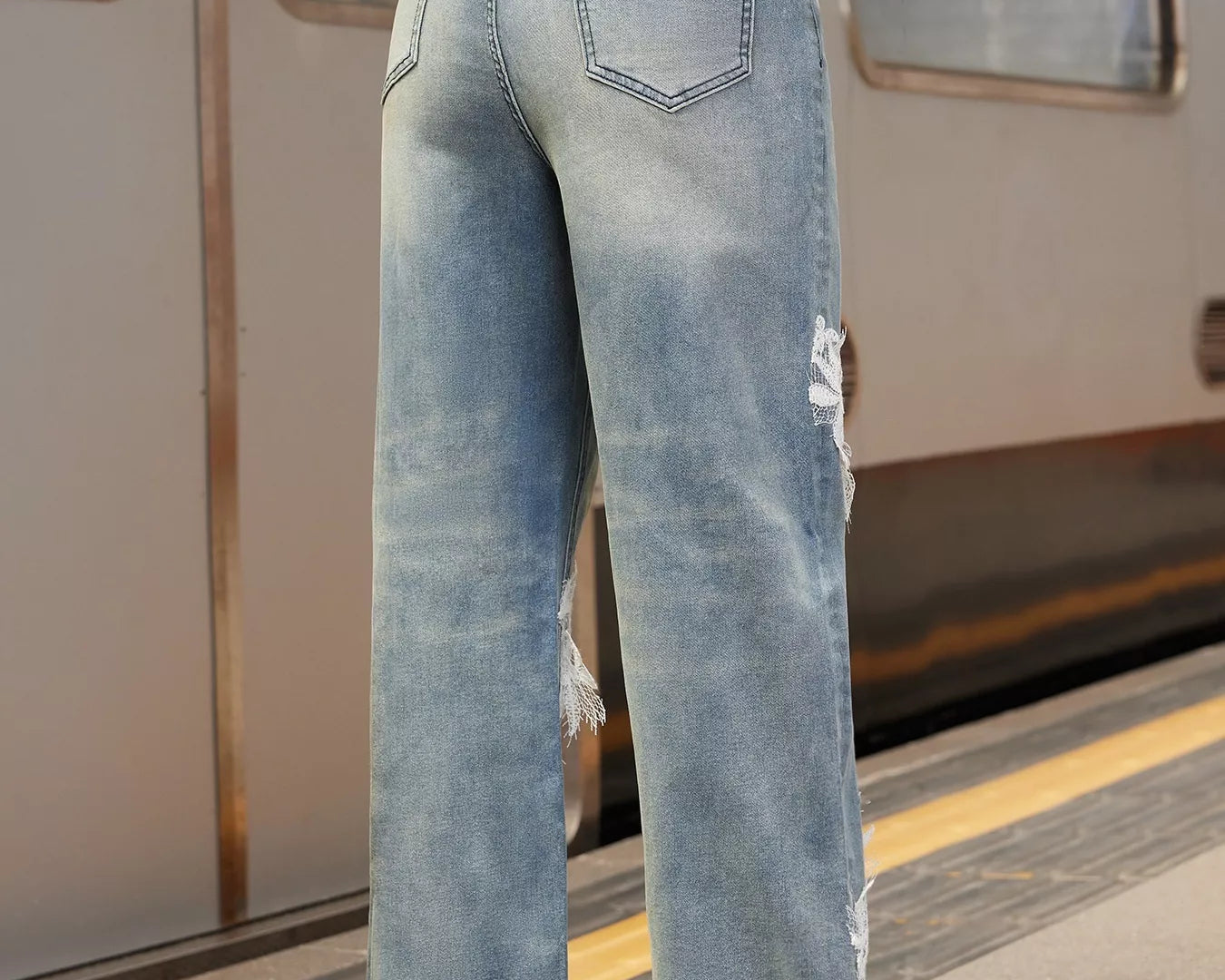 NEWYORKLISTED STYLE COLLECTION: Person wearing light blue jeans on a train platform