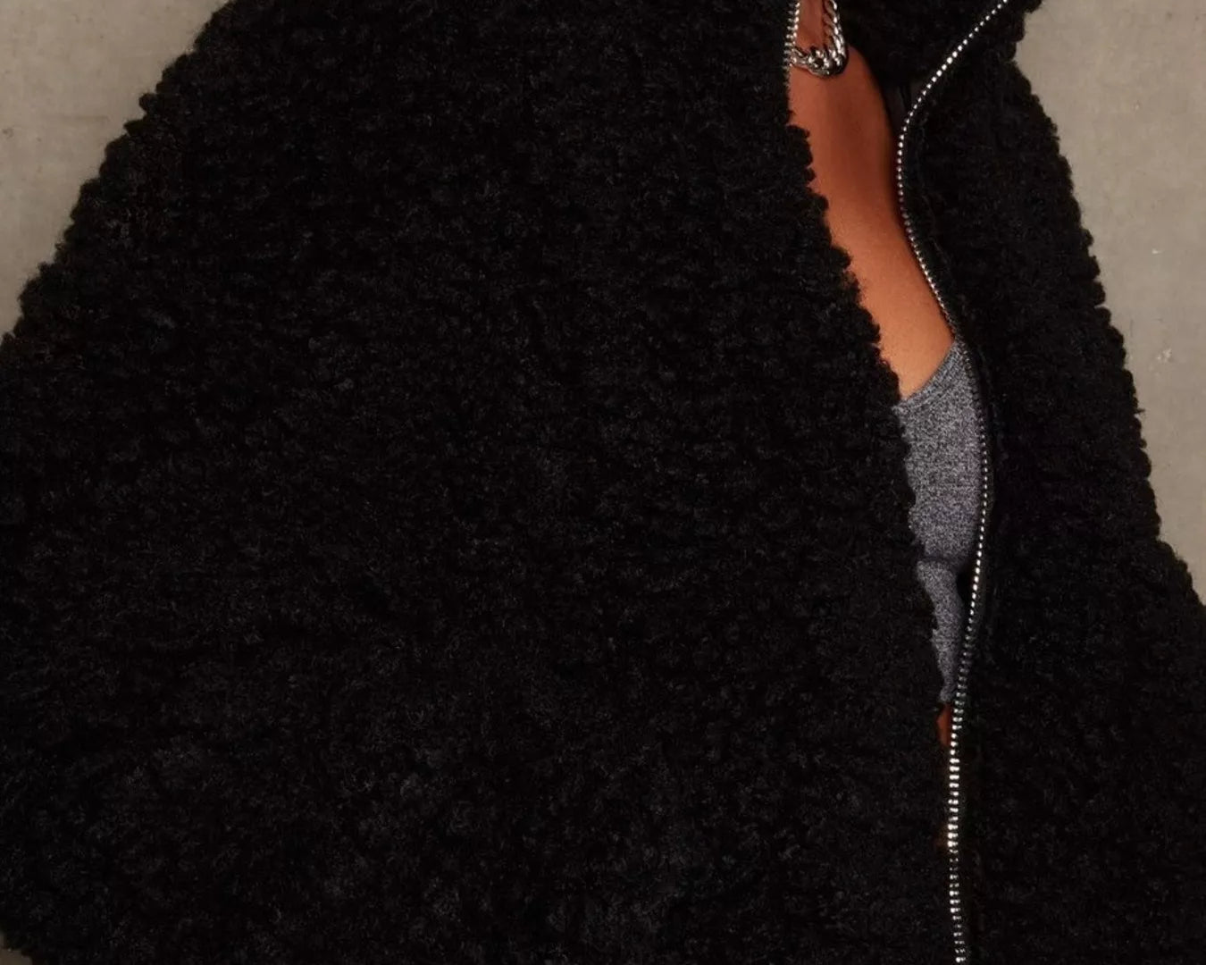 NEWYORKLISTED STYLE COLLECTION: Black fuzzy jacket worn by a person against a neutral background