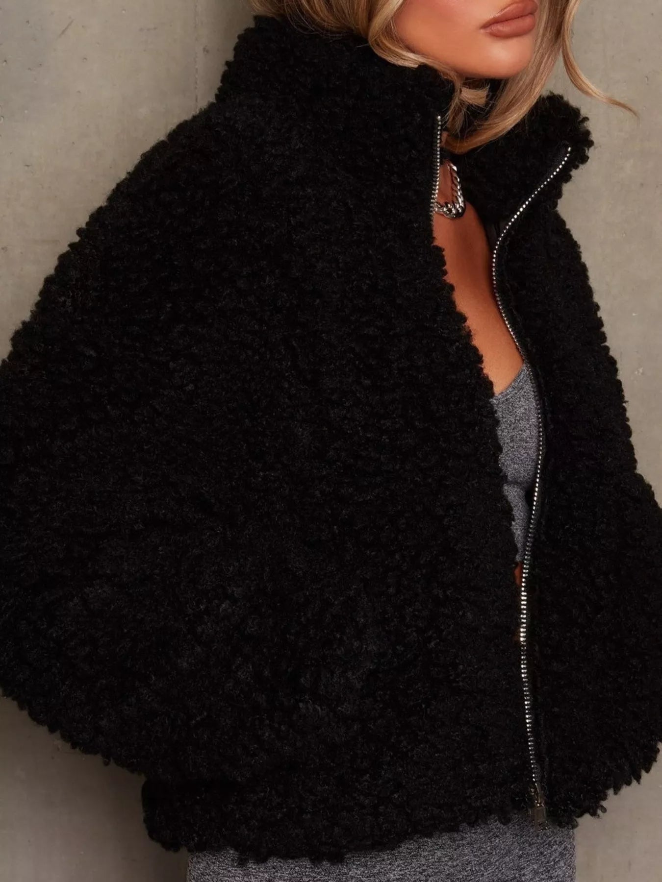 NEWYORKLISTED STYLE COLLECTION: Black fuzzy jacket worn by a person against a neutral background