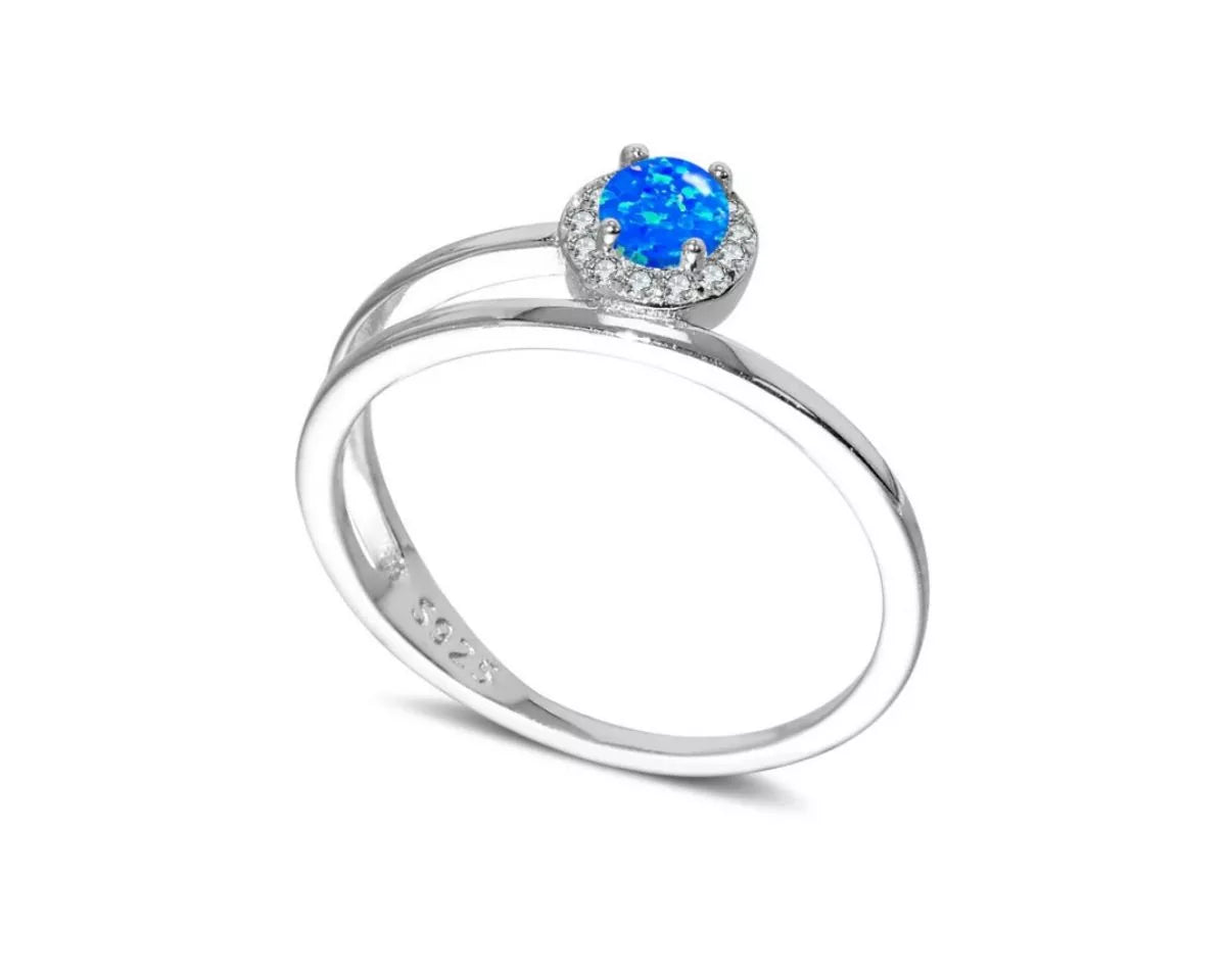 NYLD Glamour Collection by NEWYORKLISTED: Silver ring with a blue gemstone on a white background