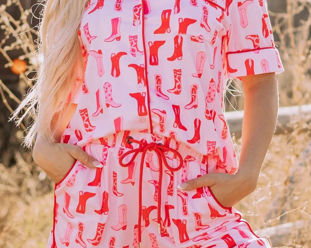 NEWYORKLISTED Intimate Apparel: Person wearing a pink and red patterned romper with a blurred outdoor background