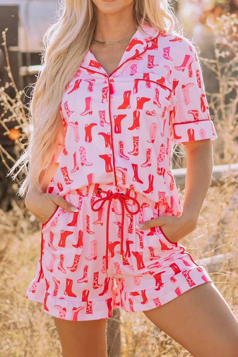 NEWYORKLISTED Intimate Apparel: Person wearing a pink and red patterned romper with a blurred outdoor background