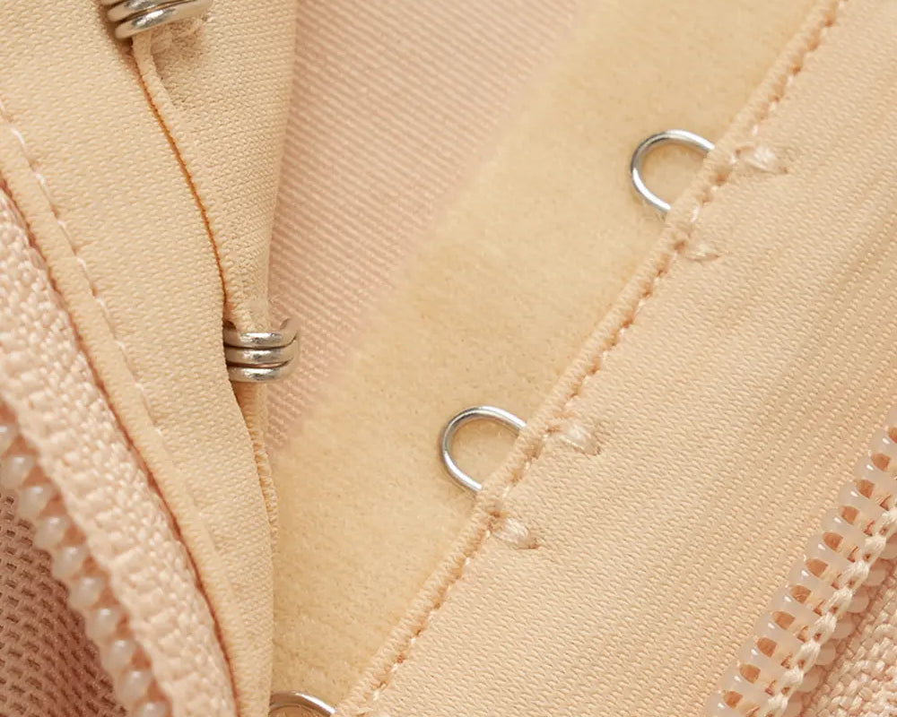 NEWYORKLISTED Intimate Apparel: Close-up of beige fabric with metal grommets and stitching details