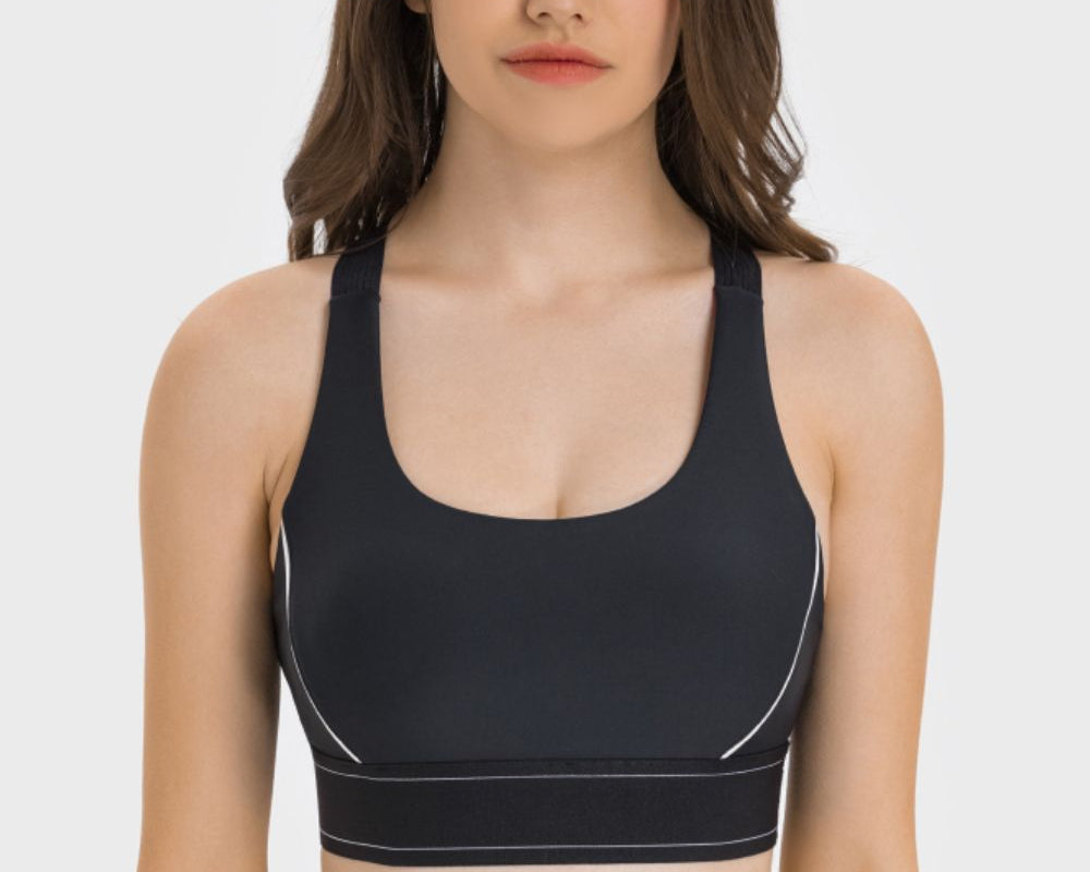 NEWYORKLISTED ACTIVEWEAR COLLECTION: Woman wearing a black sports bra and leggings on a white background