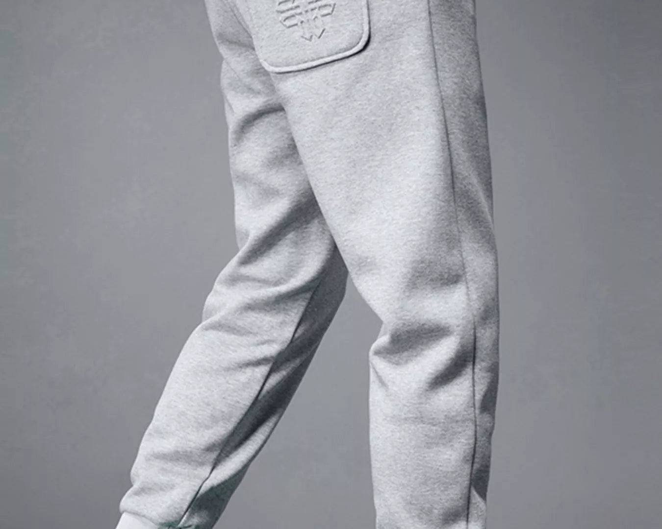 NEWYORKLISTED ATLAS MEN's COLLECTION: Gray sweatpants worn by a person with green sneakers on a gray background