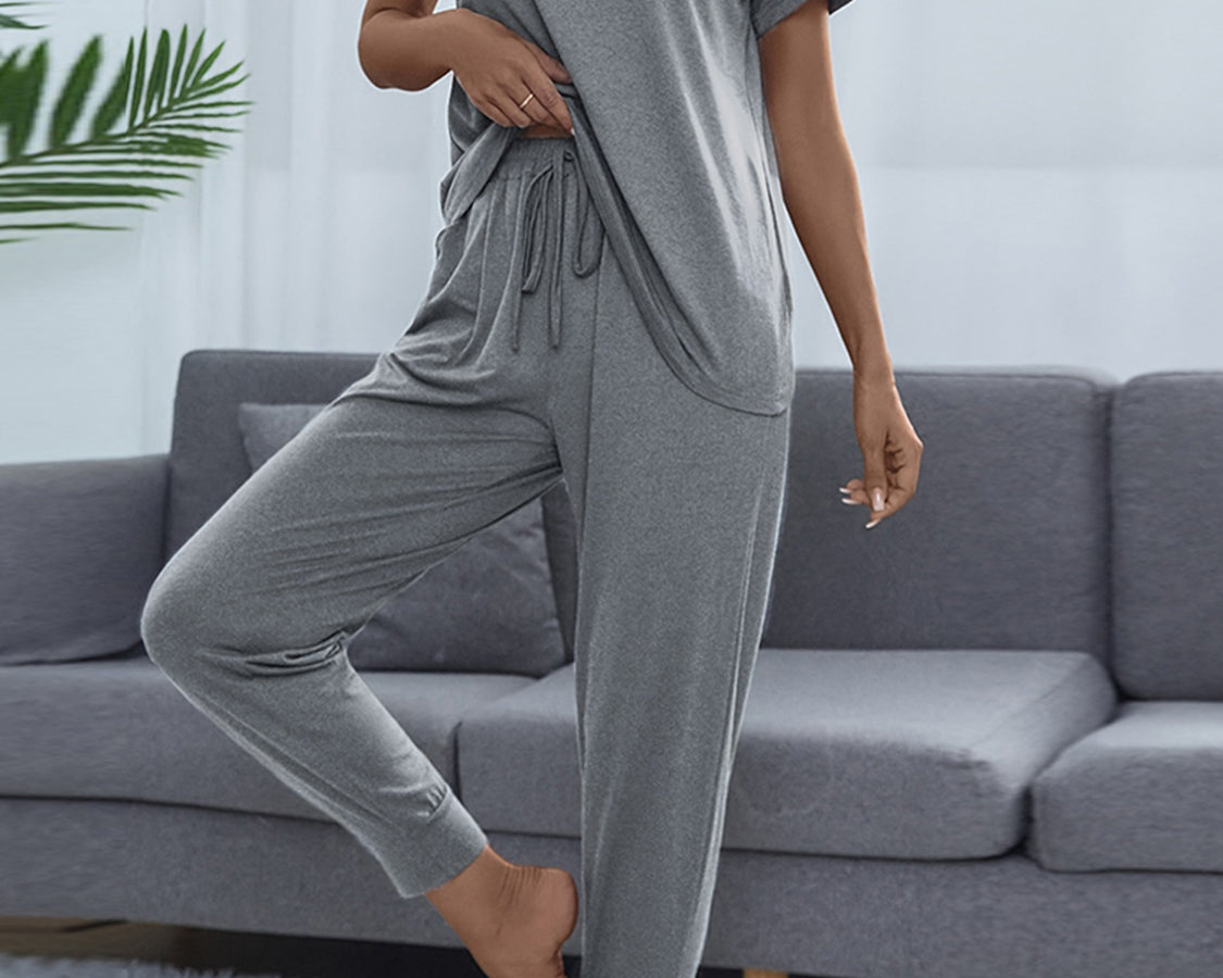 NEWYORKLISTED Intimate Apparel: Person wearing a gray lounge set in a living room setting.