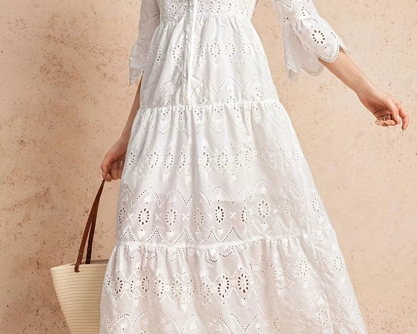 NEWYORKLISTED STYLE COLLECTION: Woman wearing a white lace dress against a beige background