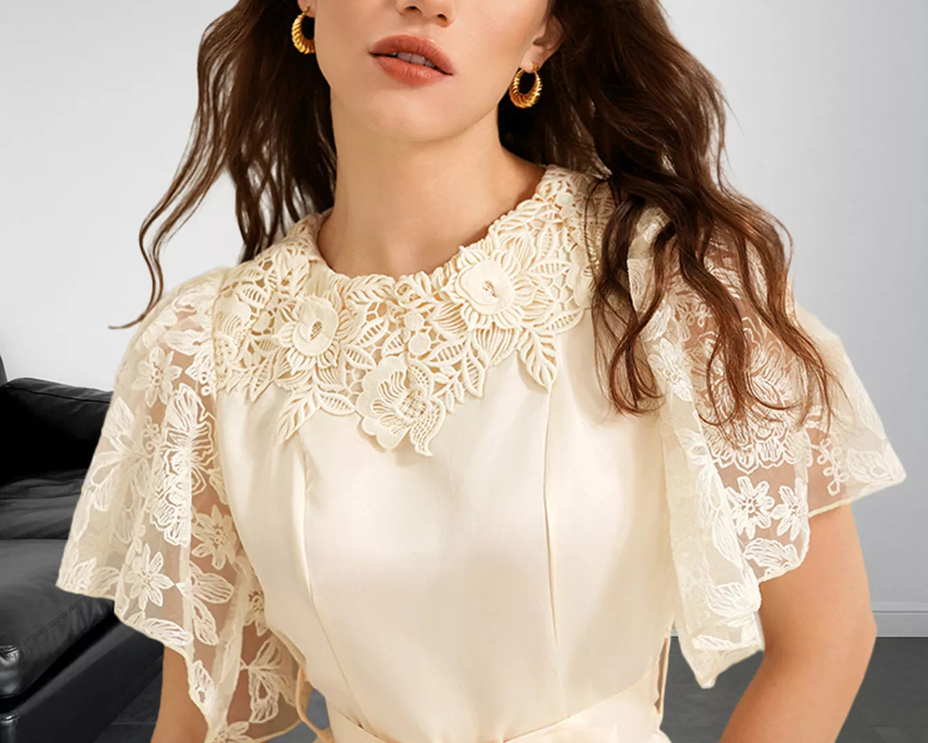 NEWYORKLISTED STYLE COLLECTION: Woman wearing a beige lace dress with a bow tie in a neutral setting