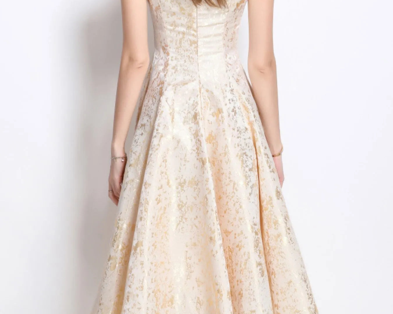 NEWYORKLISTED STYLE COLLECTION: Woman wearing a floral dress against a plain background