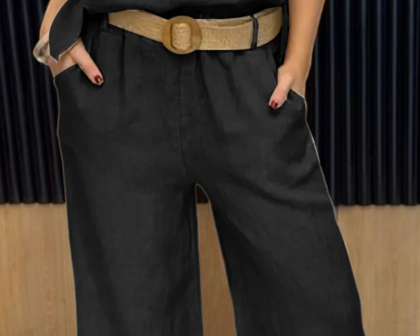 NEWYORKLISTED COMFORT COLLECTION: Person wearing a black sleeveless top and wide-leg black pants with a beige belt.