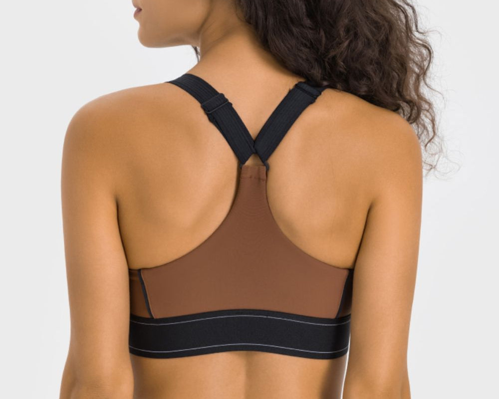 NEWYORKLISTED ACTIVEWEAR COLLECTION: Woman wearing a brown sports bra and leggings on a white background