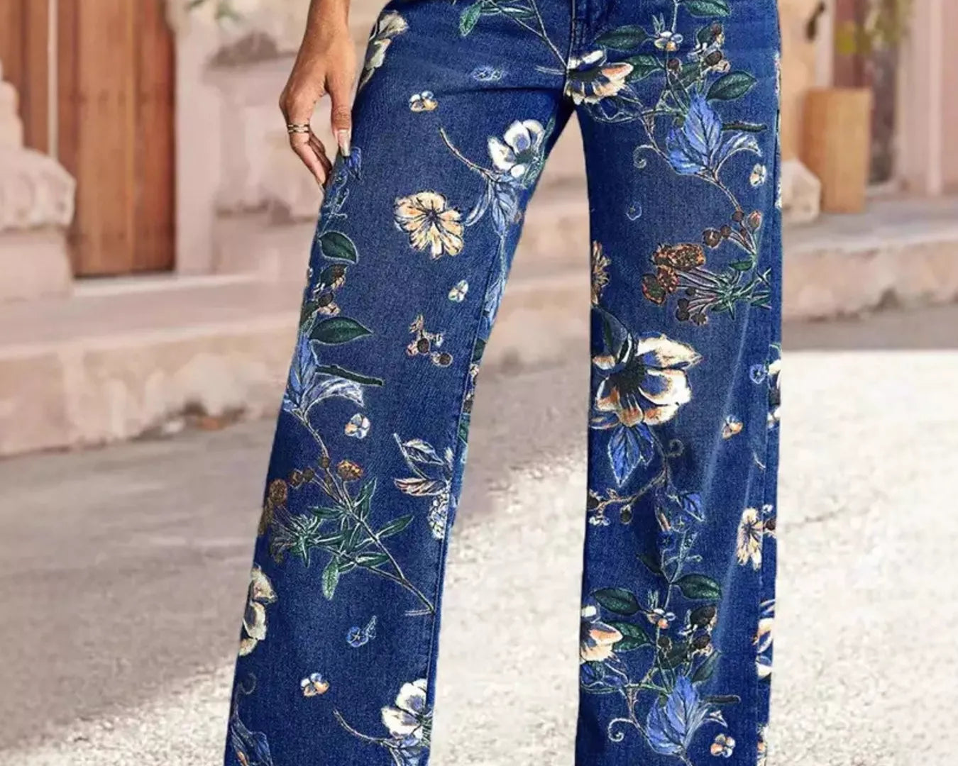 NEWYORKLISTED STYLE COLLECTION: Person wearing blue floral pants standing outdoors.