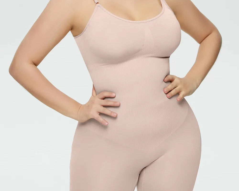 NEWYORKLISTED Intimate Apparel Collection: Woman wearing a beige shapewear bodysuit on a light gray background