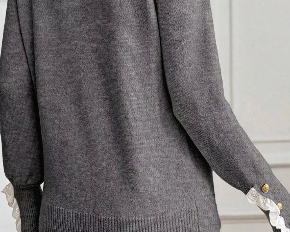 NEWYORKLISTED STYLE COLLECTION: Gray sweater with lace trim on sleeves and hem worn by a person.