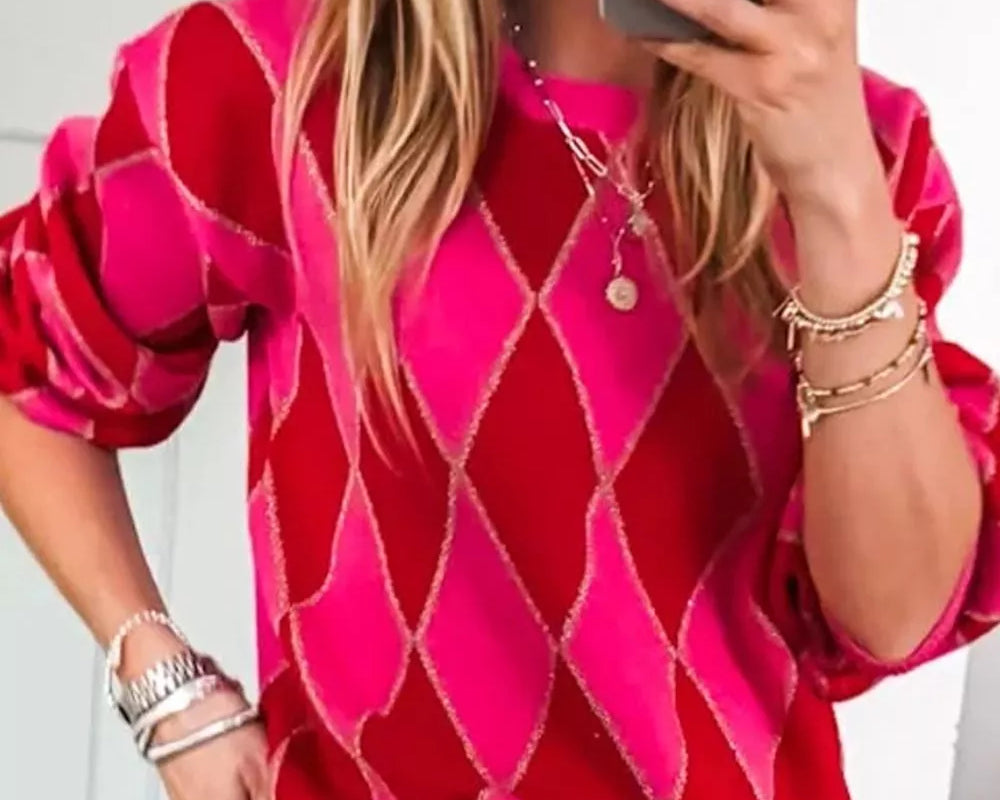 NEWYORKLISTED STYLE COLLECTION: Person wearing a pink diamond patterned top and blue jeans, taking a mirror selfie.