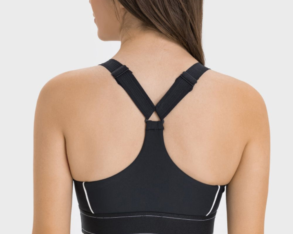 NEWYORKLISTED ACTIVEWEAR COLLECTION: Black sports bra worn by a person on a white background