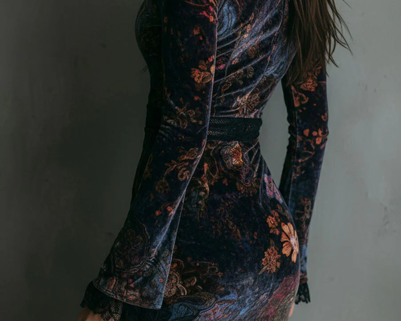 NEWYORKLISTED STYLE COLLECTION: Woman wearing a floral patterned dress against a plain background