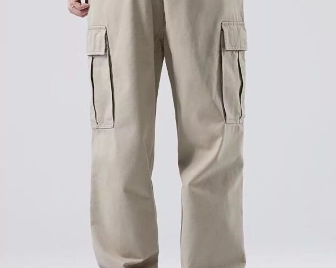 NEWYORKLISTED ATLAS MEN'S COLLECTION: Beige cargo pants worn by a person on a white background
