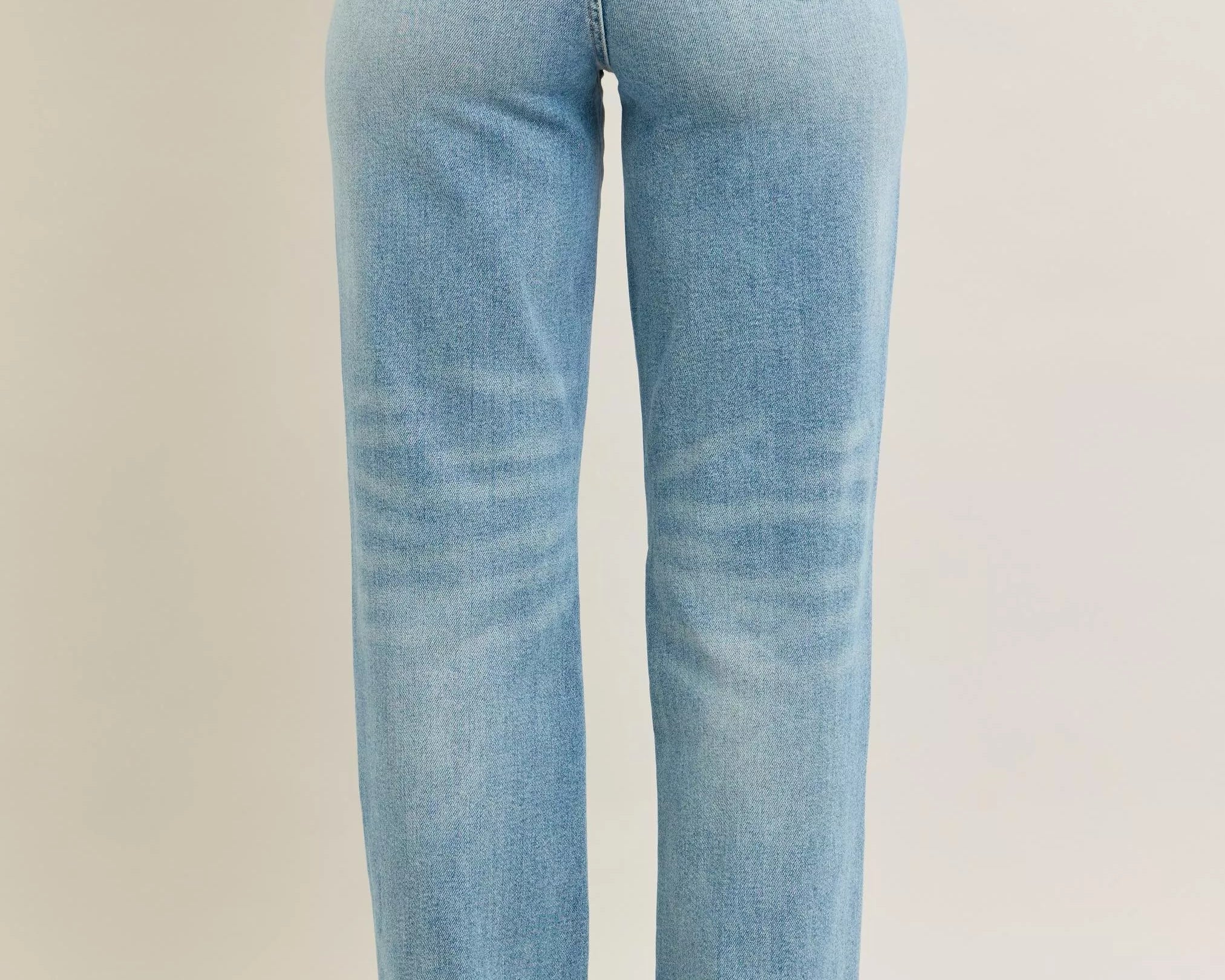 NEWYORKLISTED STYLE COLLECTION: Light blue jeans on a beige background