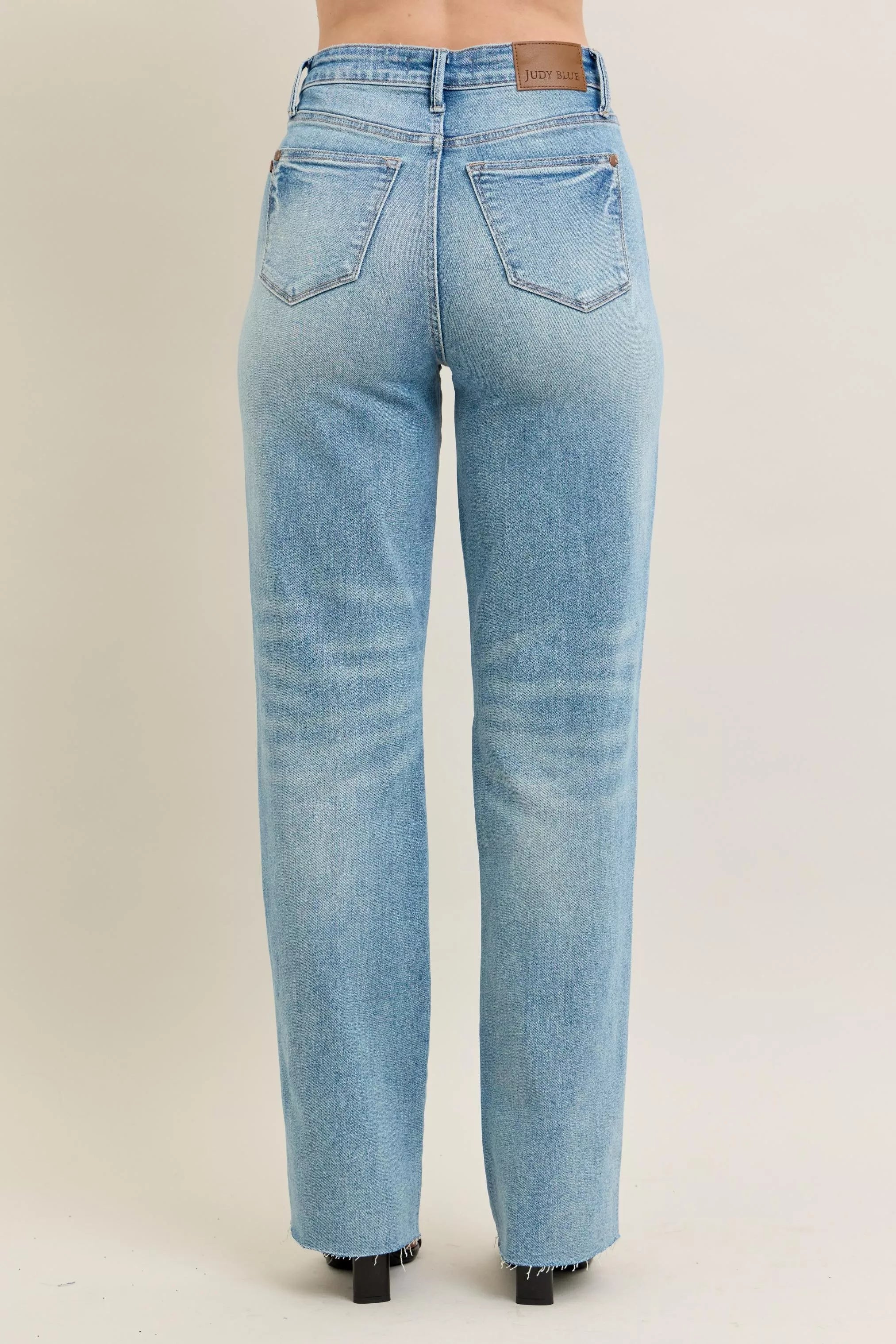 NEWYORKLISTED STYLE COLLECTION: Light blue jeans on a beige background