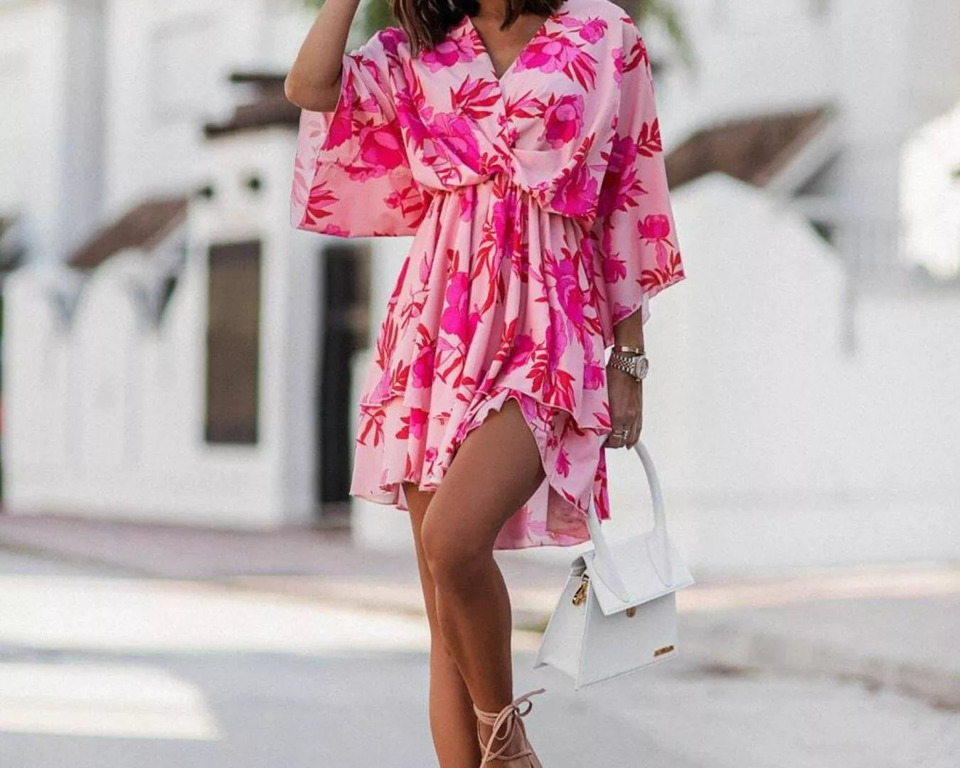 NEWYORKLISTED STYLE COLLECTION: Woman wearing a pink floral dress on a street.