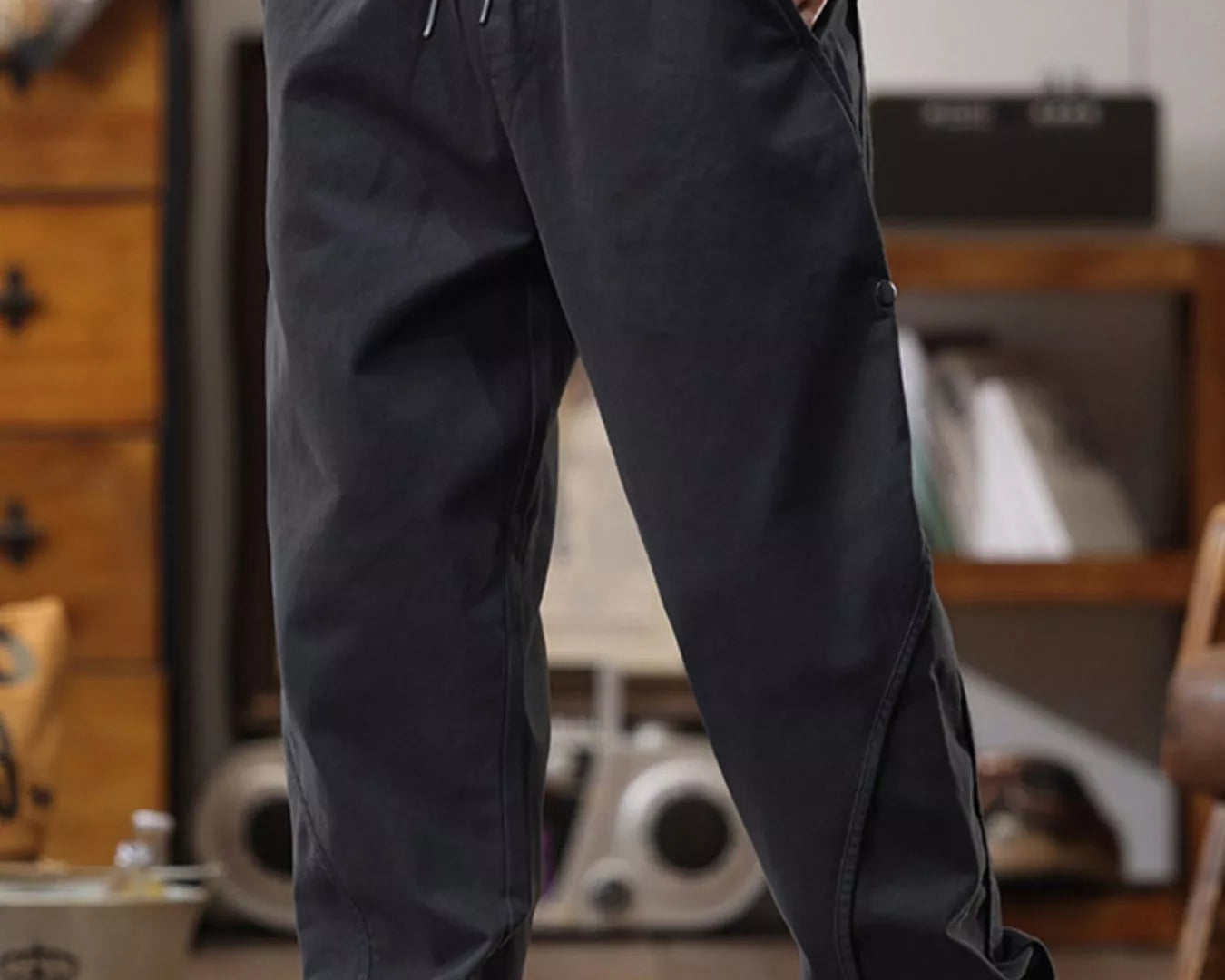 NEWYORKLISTED ATLAS MEN's COLLECTION: Person wearing black jogger pants with a blurred indoor background