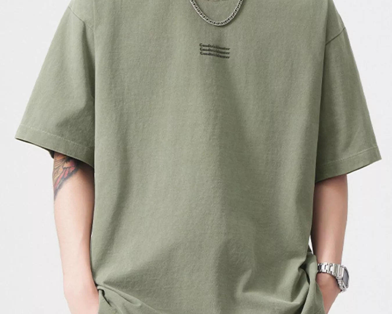 NEWYORKLISTED ATLAS MEN's COLLECTION: Person wearing an olive green t-shirt with a small logo on a white background