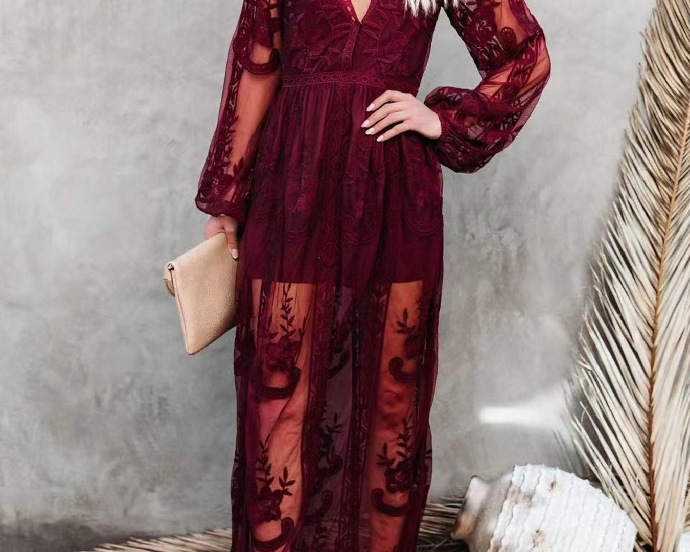 NEWYORKLISTED STYLE COLLECTION: Woman wearing a burgundy lace dress against a neutral background