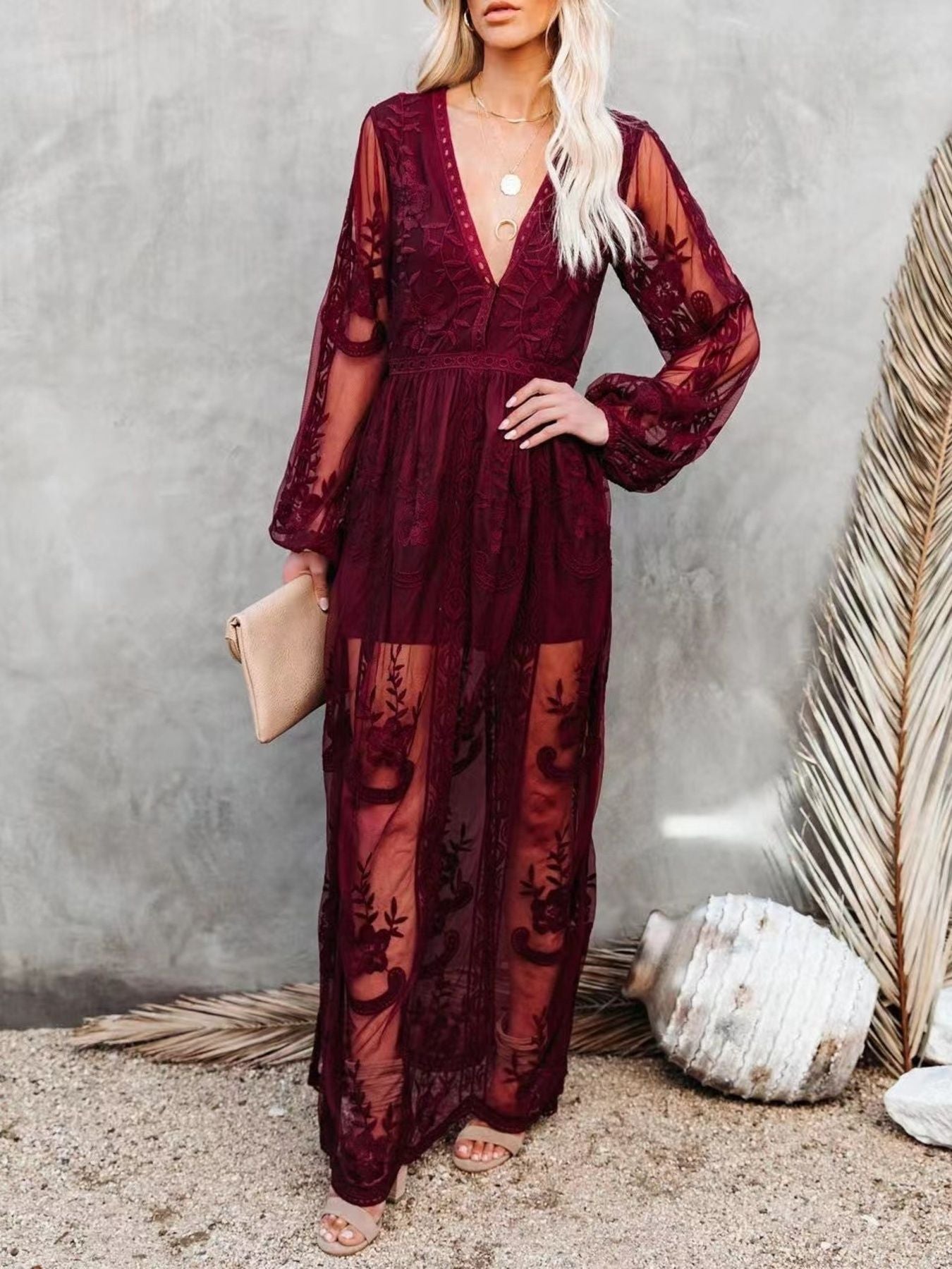 NEWYORKLISTED STYLE COLLECTION: Woman wearing a burgundy lace dress against a neutral background