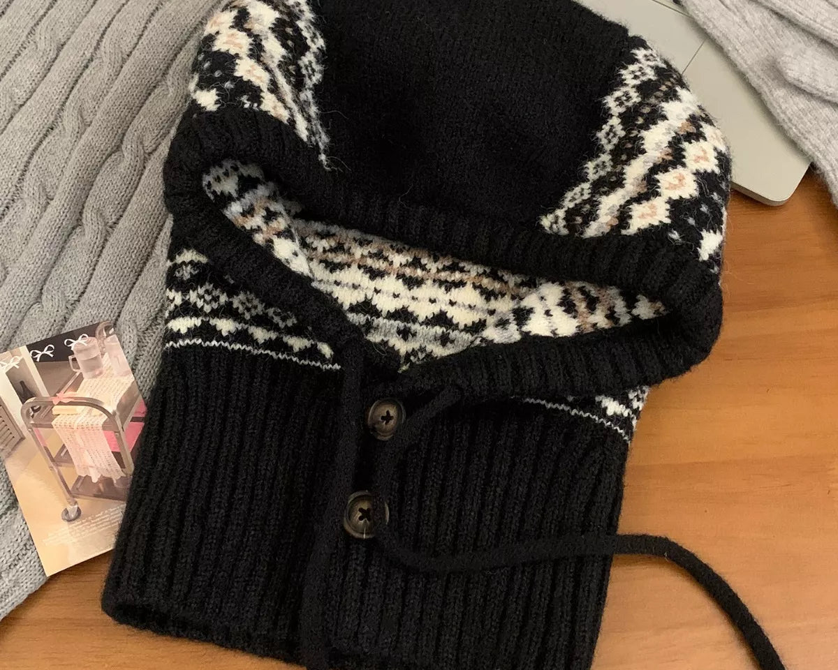 NEWYORKLISTED STYLE COLLECTION: Drawstring Knitted Winter Hat – Cozy, Chic & Cold-Weather Ready: Black and white patterned knitted cowl on a wooden surface with a laptop and magazine in the background.