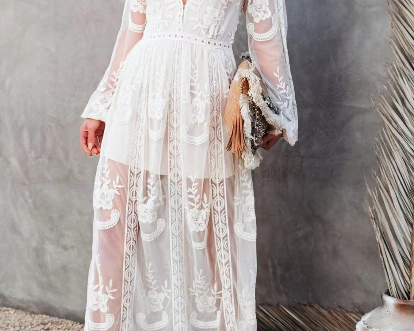 NEWYORKLISTED STYLE COLLECTION: Woman wearing a white lace dress against a neutral background