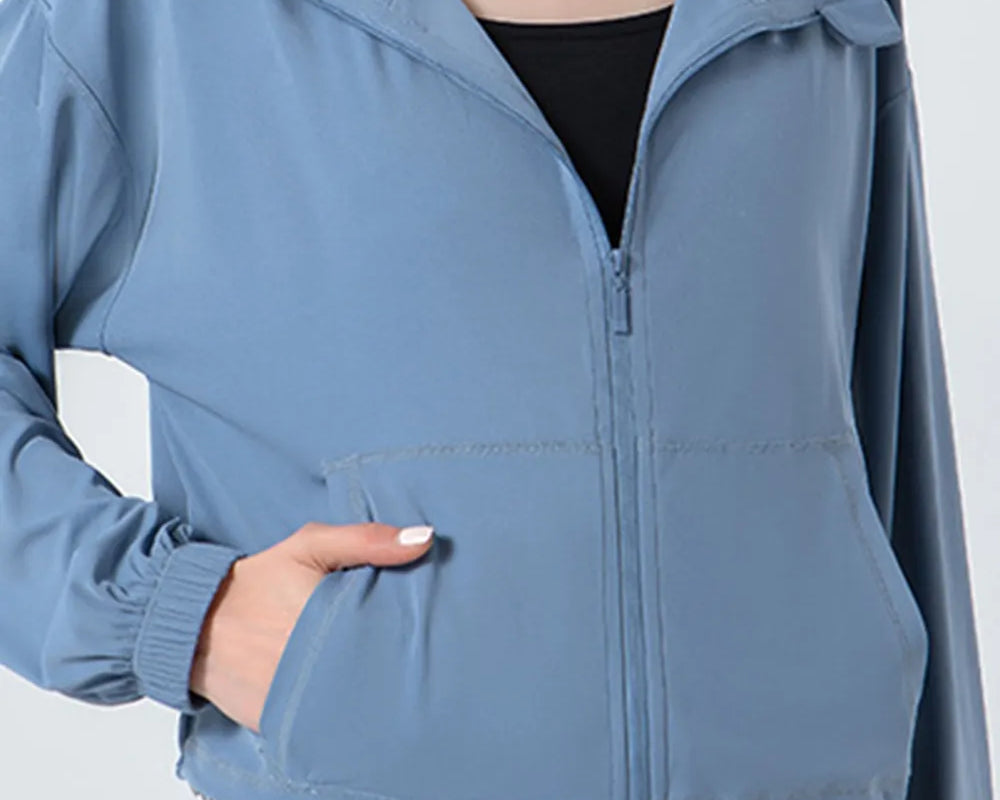 NEWYORKLISTED ACTIVEWEAR COLLECTION: Blue jacket worn by a person on a white background