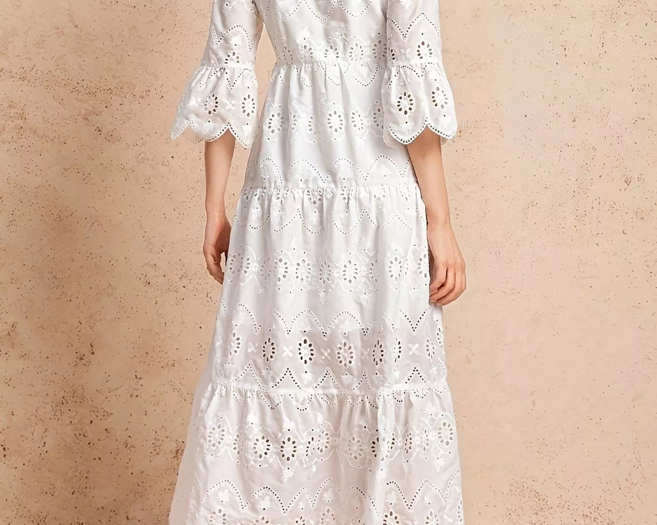 NEWYORKLISTED STYLE COLLECTION: White lace dress on a beige background