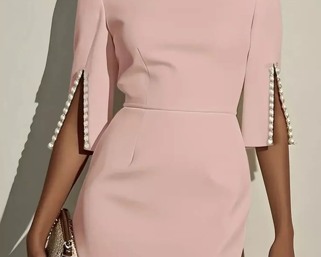 NEWYORKLISTED STYLE COLLECTION: Pink dress with pearl embellishments on sleeves against a neutral background