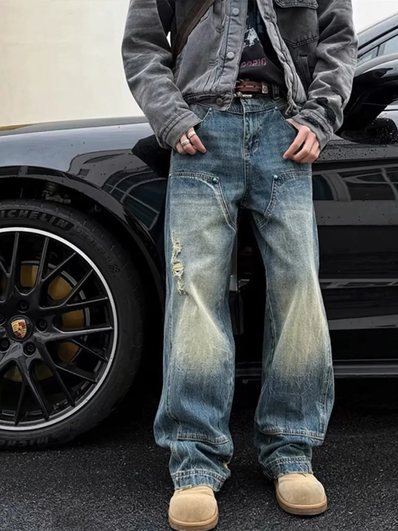 NEWYORKLISTED ATLAS MEN's COLLECTION: Person wearing distressed blue jeans standing next to a car