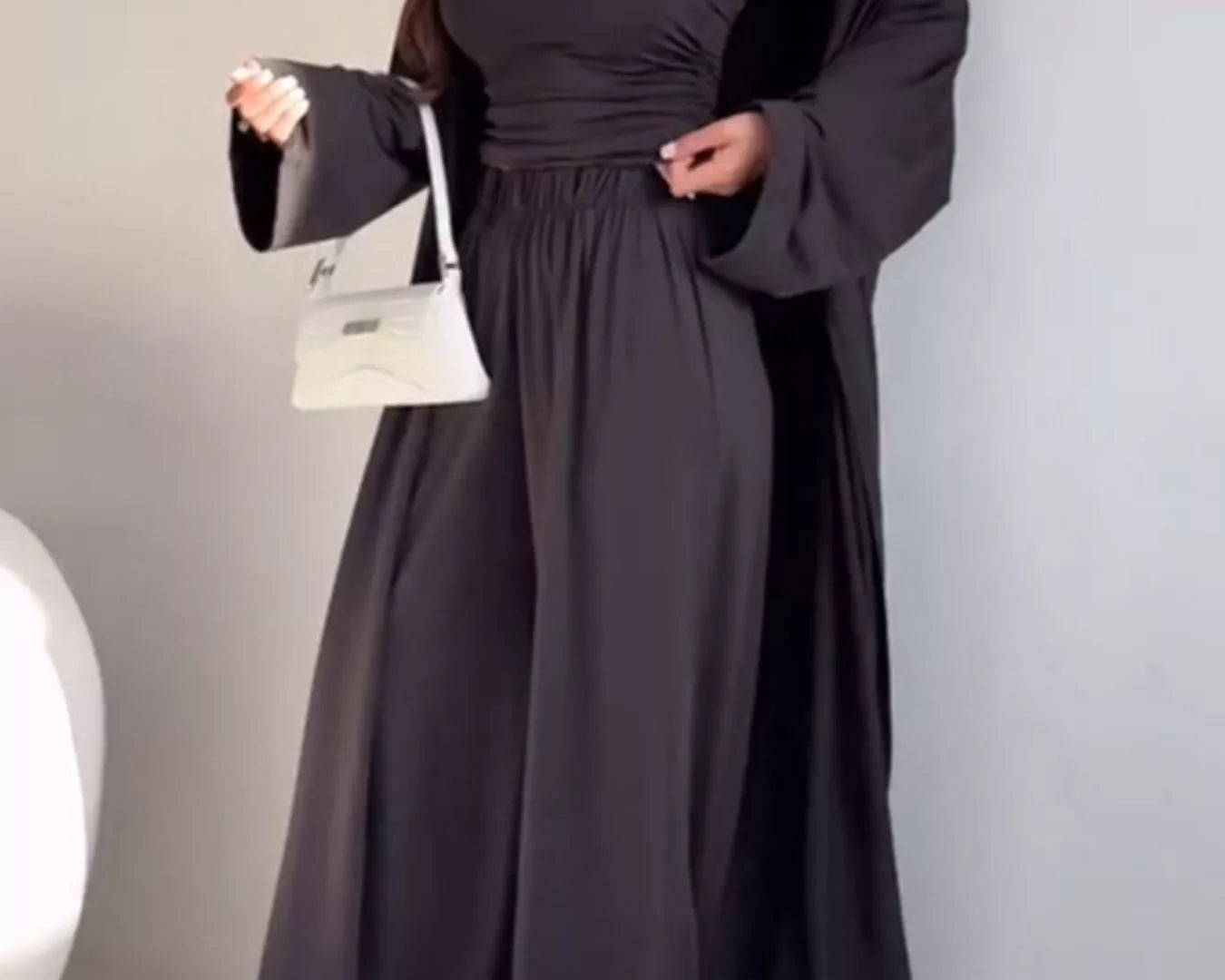 NEWYORKLISTED COMFORT COLLECTION: Woman wearing a long black dress with a white background