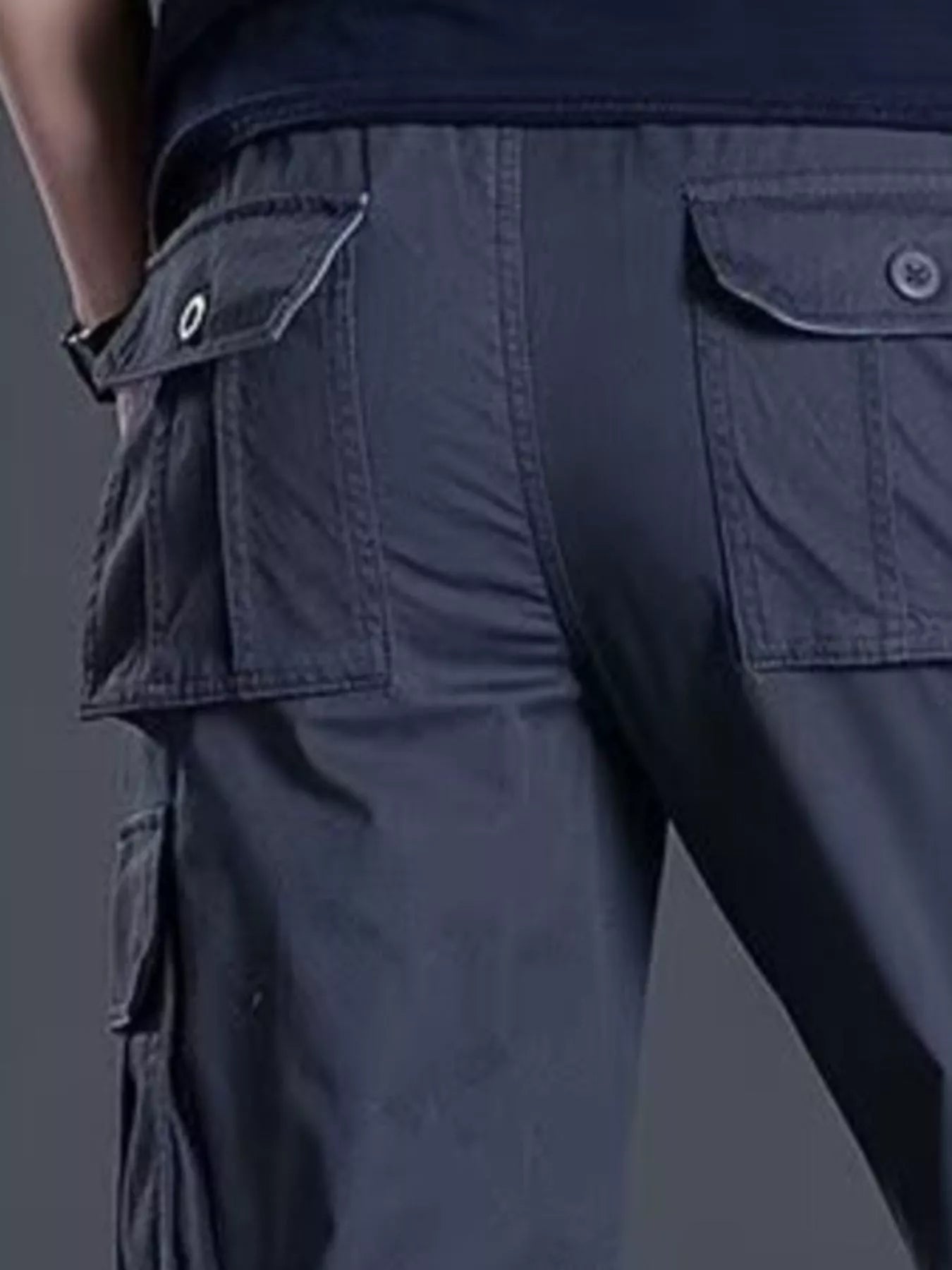 NEWYORKLISTED ATLAS MEN's COLLECTION: Navy blue cargo pants with multiple pockets on a dark background