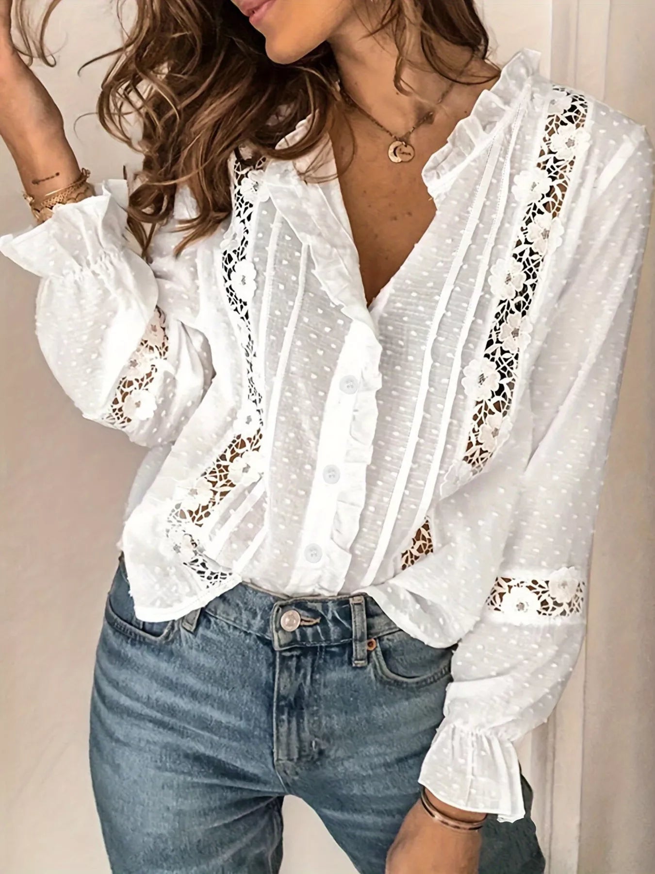 NEWYORKLISTED STYLE COLLECTION: White blouse with lace details worn by a person against a neutral background